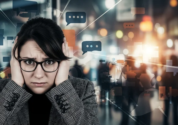 Person feeling overwhelmed in a chaotic, loud environment.